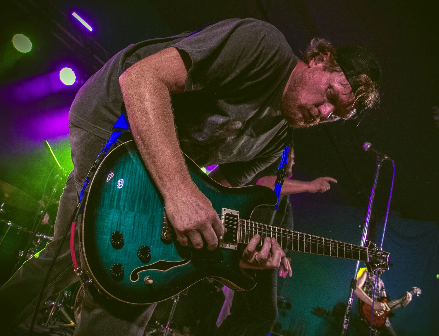 Claim To Flame guitarist performing with green guitar